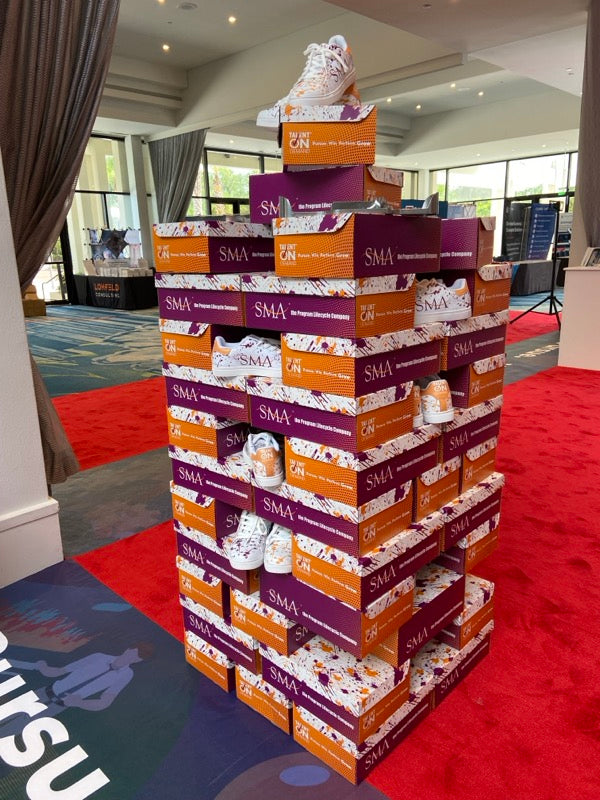 SMA branded shoe boxes stacked at event