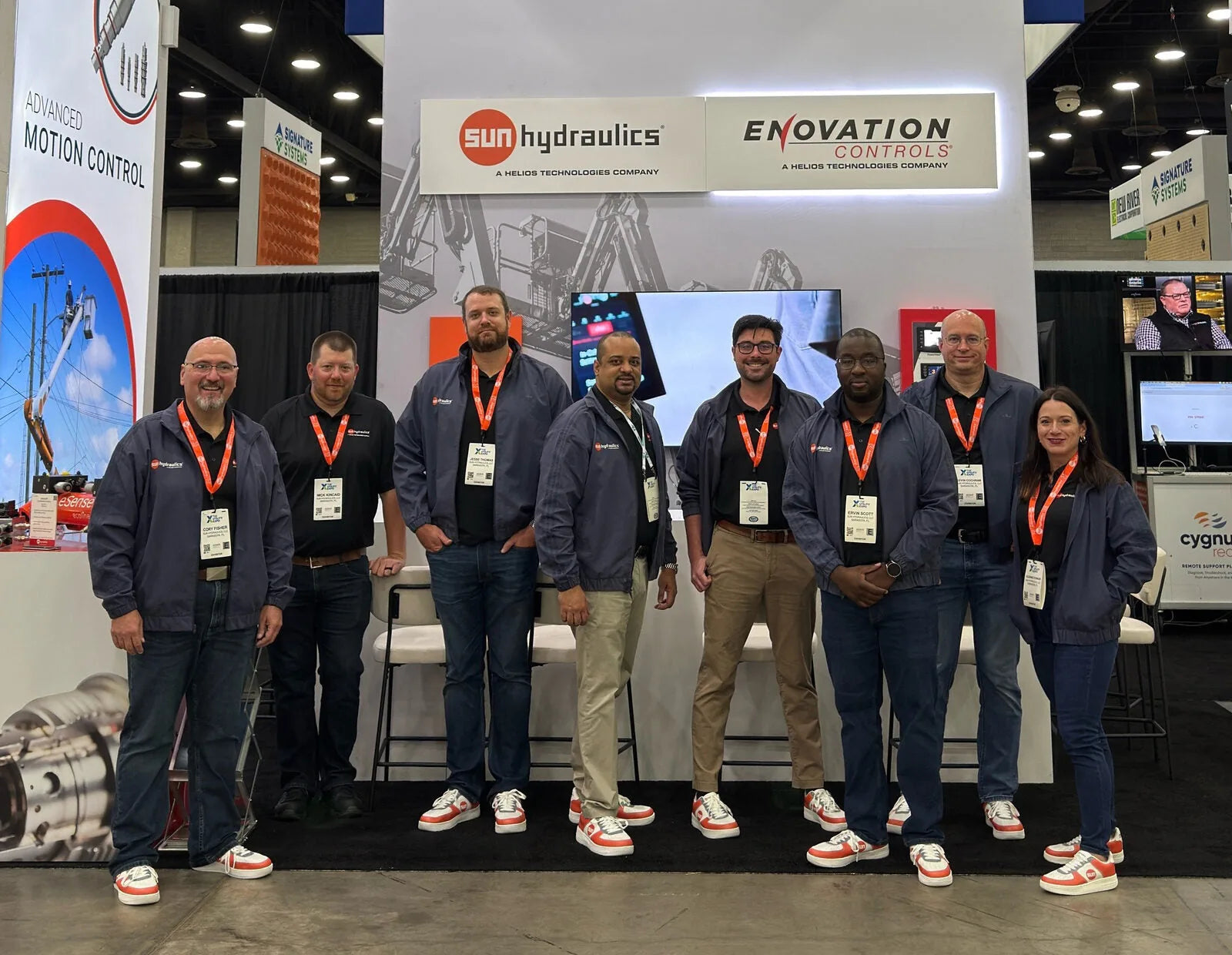 Sun Hydraulics team in matching custom red and white branded sneakers at booth