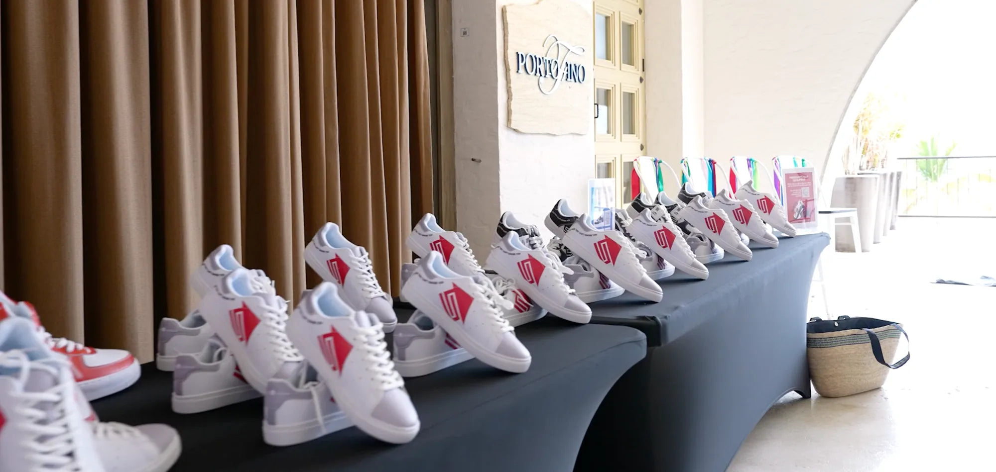 Portofino case study event display showing custom branded shoes lined up on a presentation table